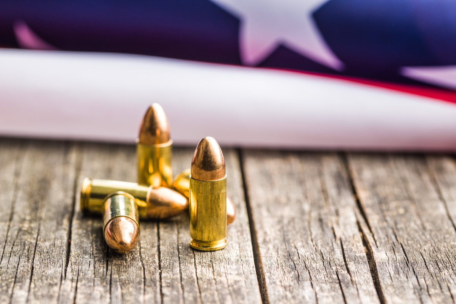 657b38d533be02965df16974_rsz_pistol-bullet-and-usa-flag-2023-11-27-05-21-33-utc-1