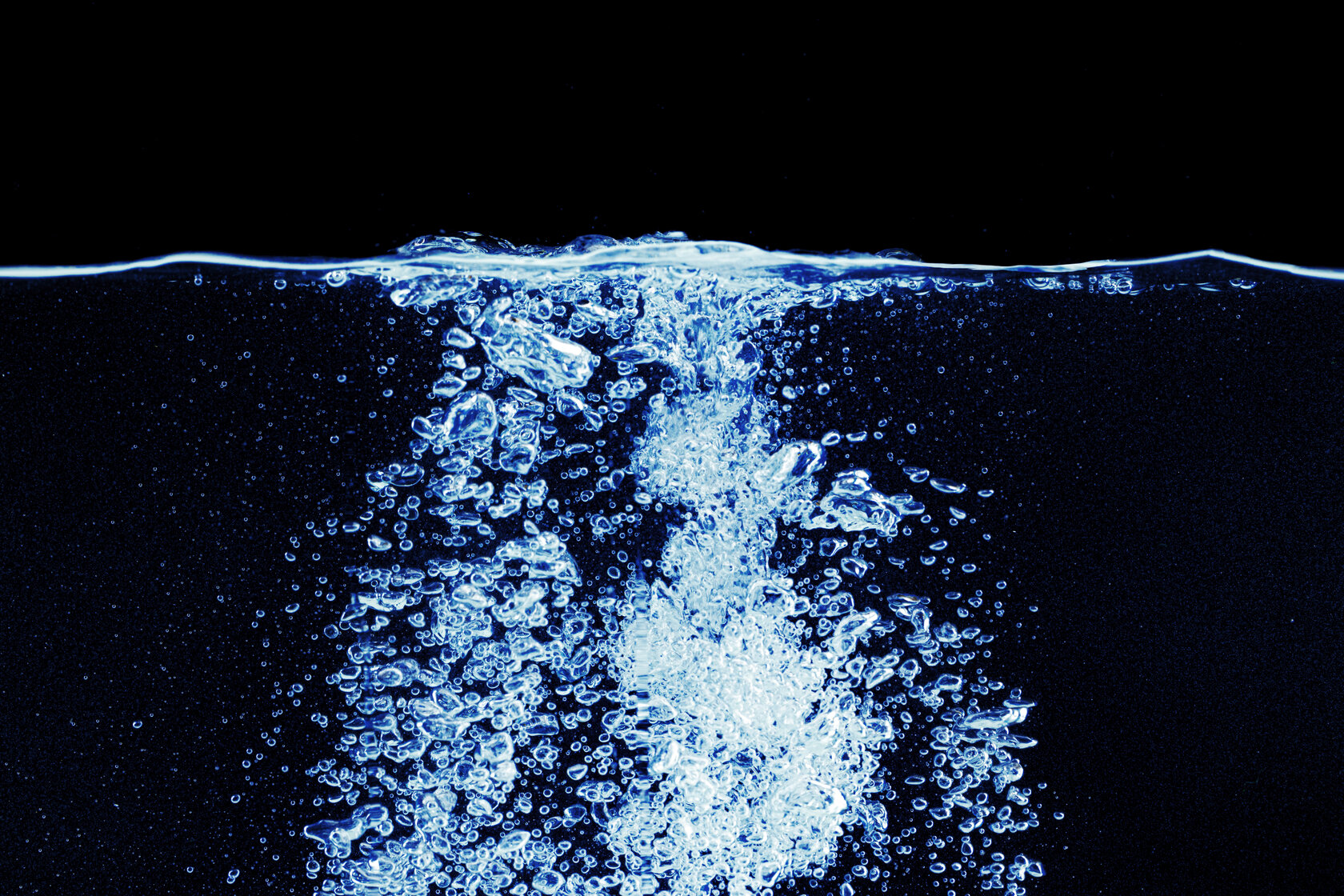 Water splash in aquarium isolated on black background