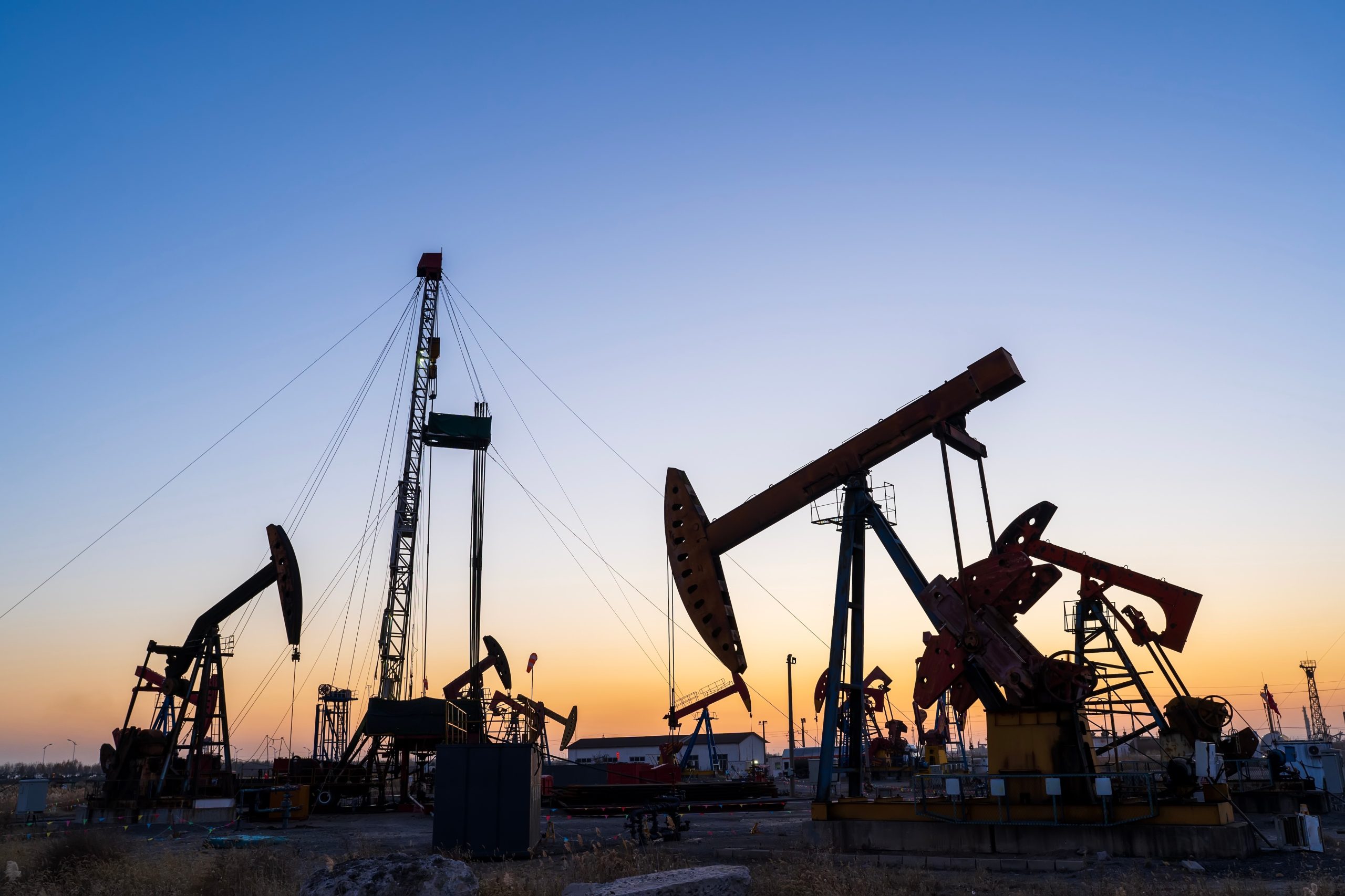 Oil,Field,,Oil,Drilling,Rig,In,The,Evening